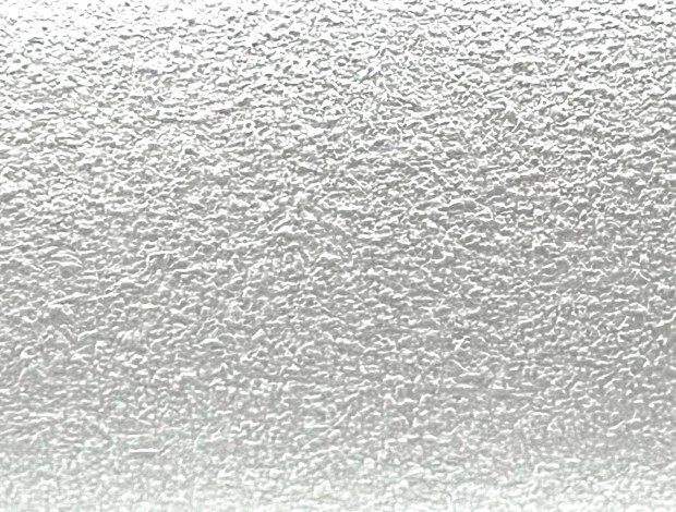 Close-up of a textured metallic surface with a silver finish.